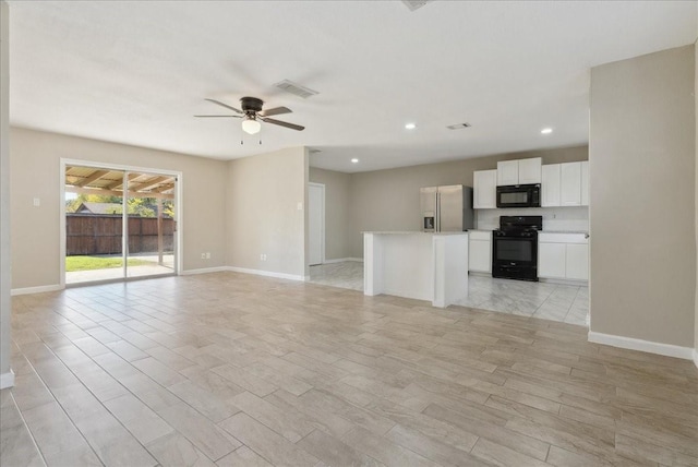 unfurnished living room featuring ceiling fan and light hardwood / wood-style flooring