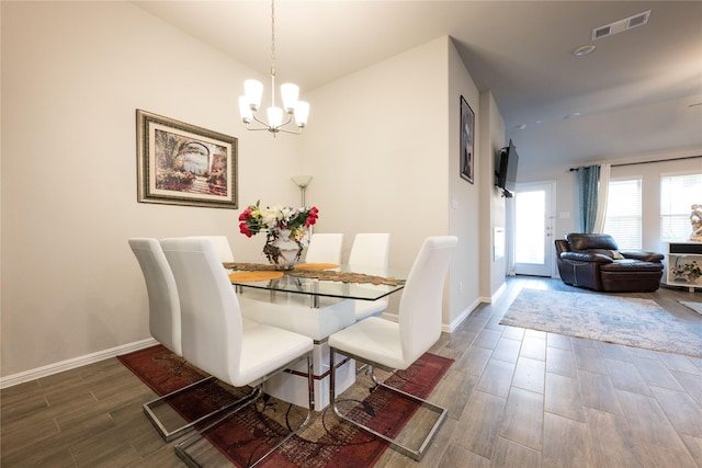 dining space featuring a notable chandelier and dark hardwood / wood-style floors