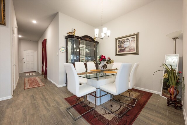 dining area with a notable chandelier and dark wood-type flooring