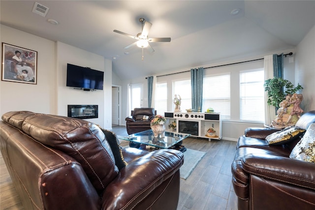 living room featuring hardwood / wood-style flooring, vaulted ceiling, and ceiling fan