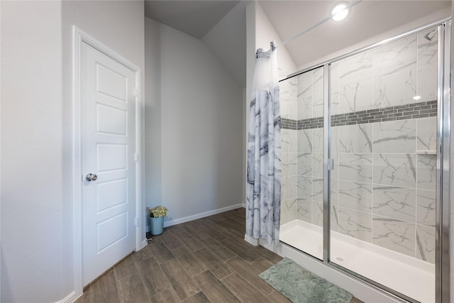 bathroom with wood-type flooring and walk in shower