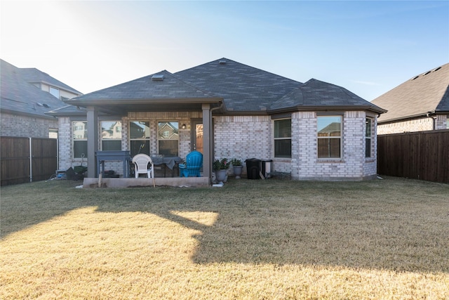 back of house with a yard and a patio area