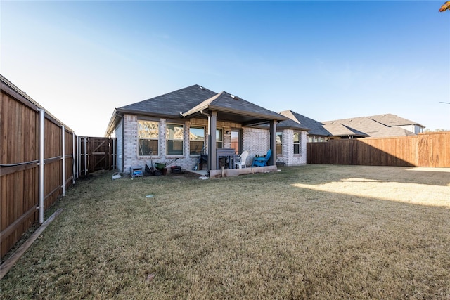 rear view of house featuring a lawn