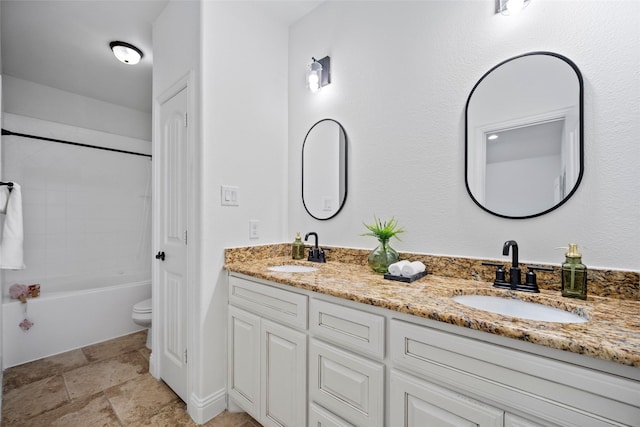 full bathroom featuring vanity, toilet, and washtub / shower combination