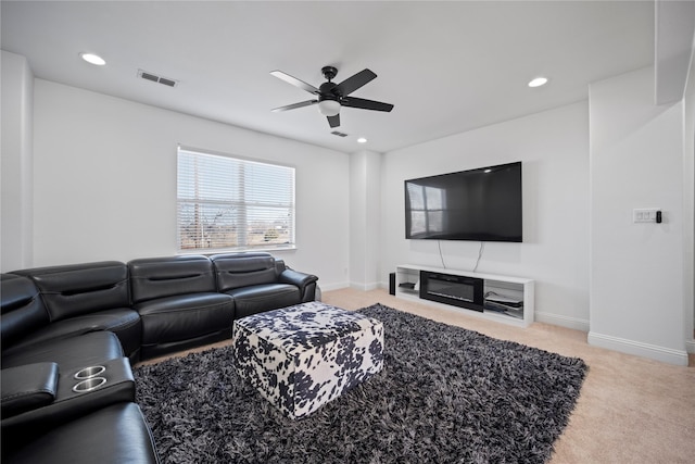 carpeted living room with ceiling fan