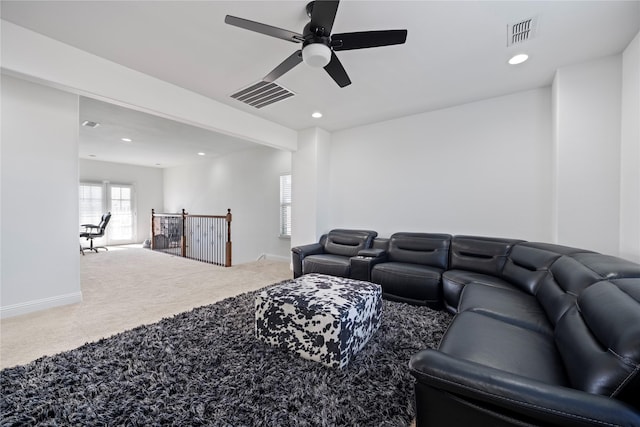 carpeted living room featuring ceiling fan