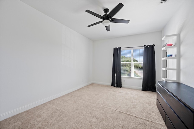 carpeted spare room featuring ceiling fan