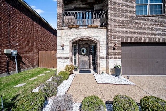 view of exterior entry featuring a garage and a yard