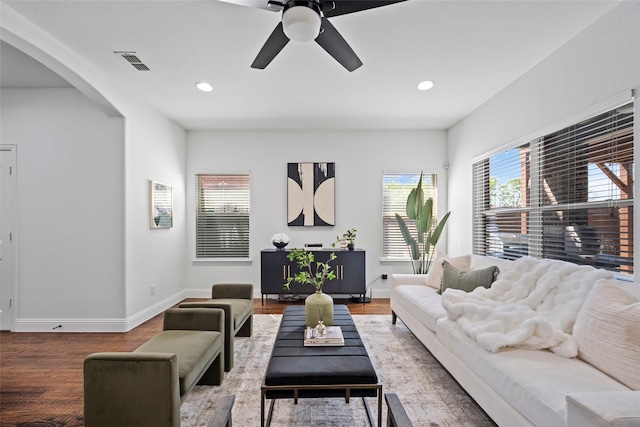 living room featuring hardwood / wood-style floors and ceiling fan