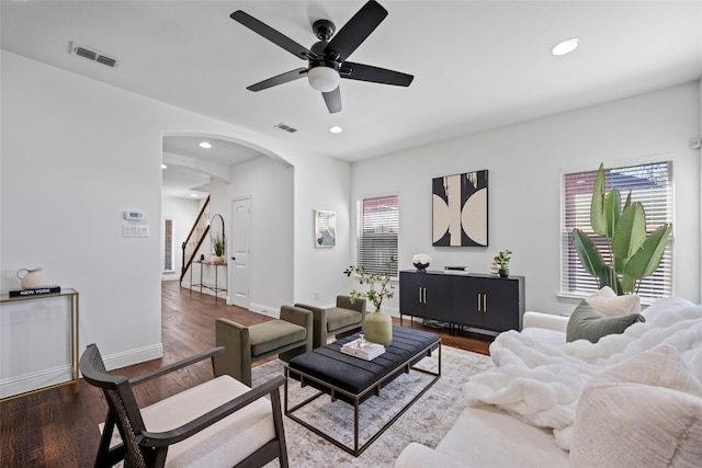 living room featuring ceiling fan and hardwood / wood-style flooring