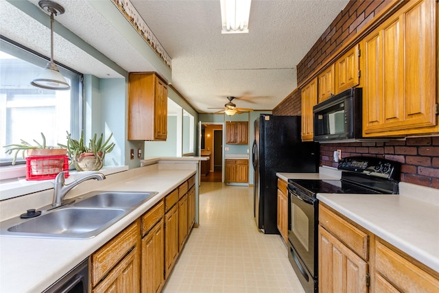 kitchen with sink, ceiling fan, hanging light fixtures, black appliances, and a textured ceiling