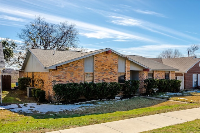 view of front of house featuring a front yard and central AC