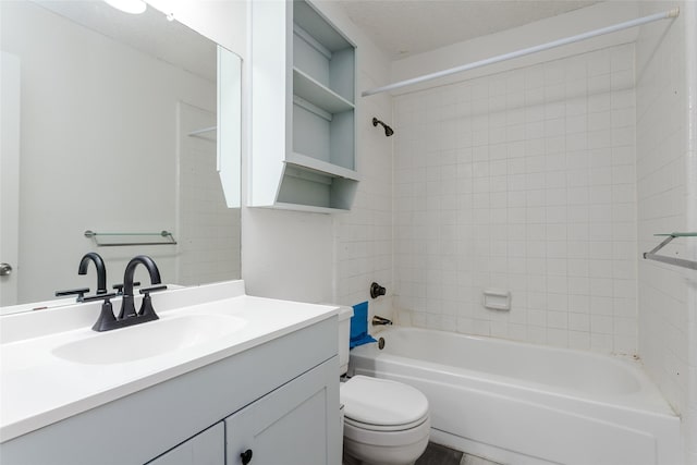 full bathroom featuring vanity, tiled shower / bath combo, a textured ceiling, and toilet