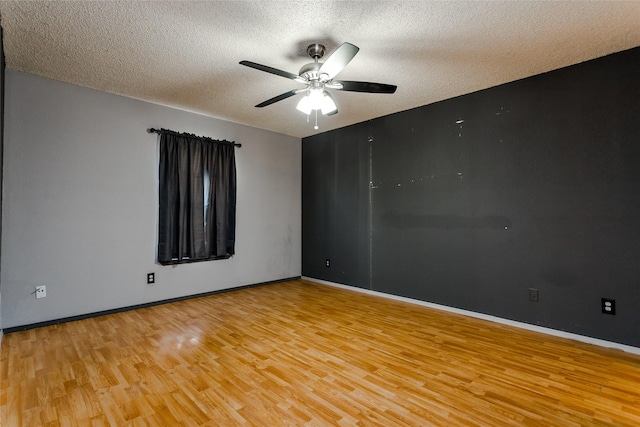 spare room featuring ceiling fan, a textured ceiling, and light hardwood / wood-style flooring