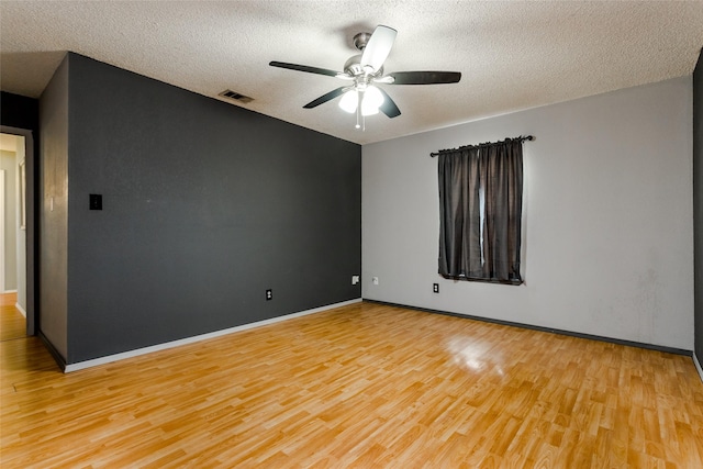 unfurnished room with ceiling fan, a textured ceiling, and light hardwood / wood-style floors