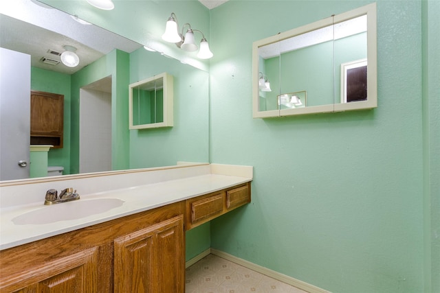 bathroom with vanity and toilet