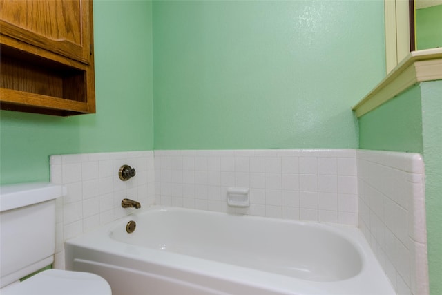 bathroom featuring a bathing tub and toilet