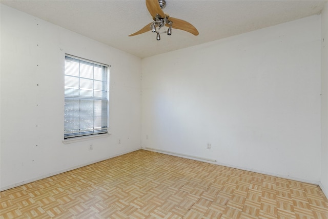 unfurnished room featuring ceiling fan, a textured ceiling, and light parquet flooring