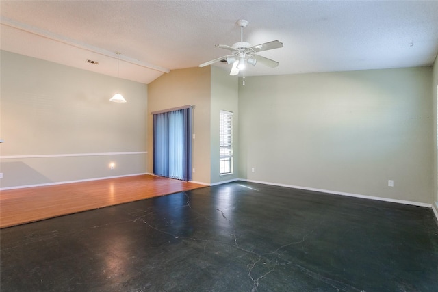 unfurnished room featuring concrete flooring, vaulted ceiling, a textured ceiling, and ceiling fan