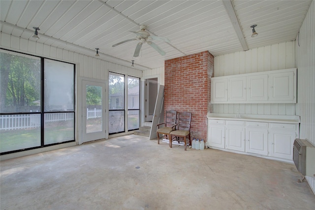 interior space with ceiling fan