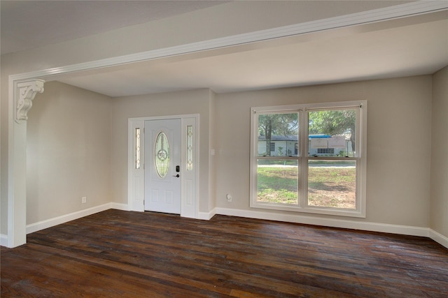 foyer entrance with dark wood finished floors and baseboards