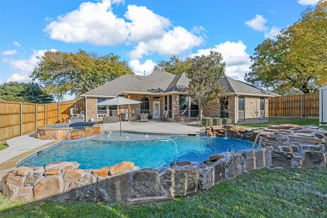 view of pool with an in ground hot tub, pool water feature, and a patio