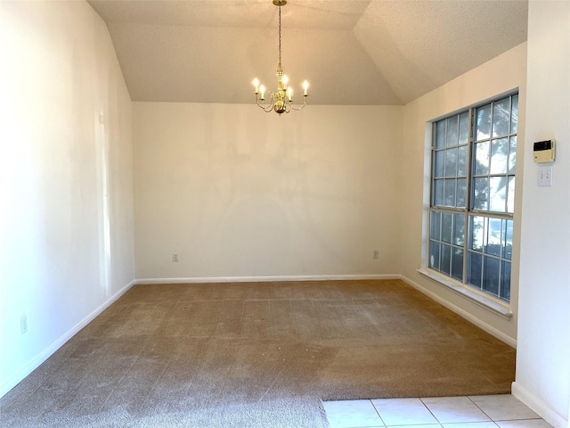 empty room with a textured ceiling, light colored carpet, an inviting chandelier, and lofted ceiling