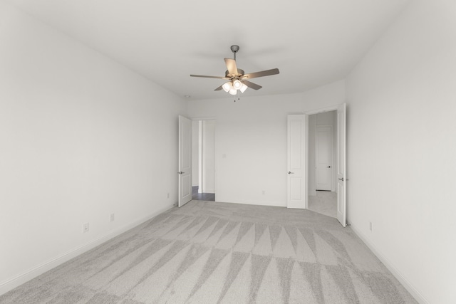 unfurnished room featuring ceiling fan and light colored carpet