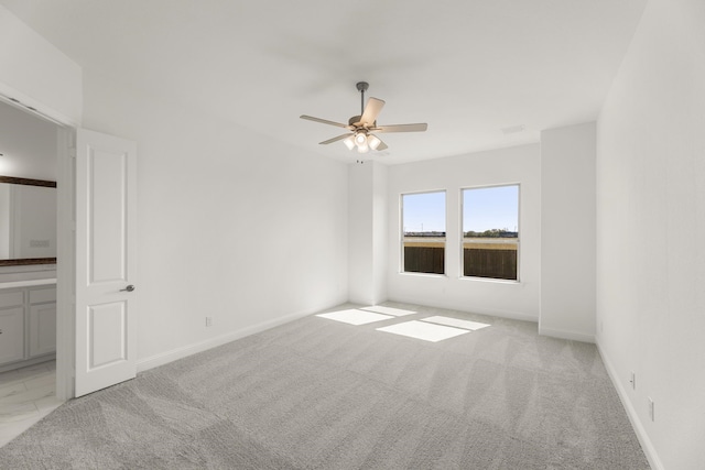 spare room with light carpet and ceiling fan