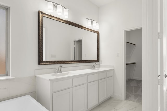 bathroom with vanity and a bath