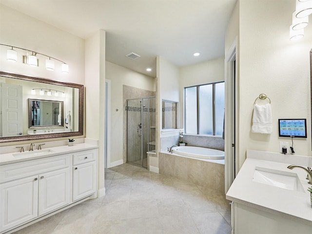 bathroom with plus walk in shower, vanity, and tile patterned flooring