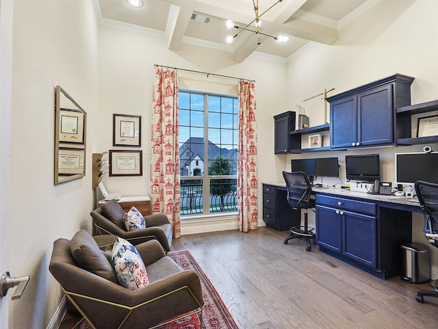 office area with an inviting chandelier, coffered ceiling, built in desk, light wood-type flooring, and beamed ceiling