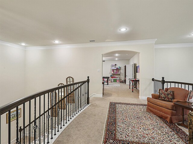 hall with light carpet and crown molding