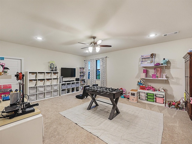 rec room featuring carpet flooring and ceiling fan