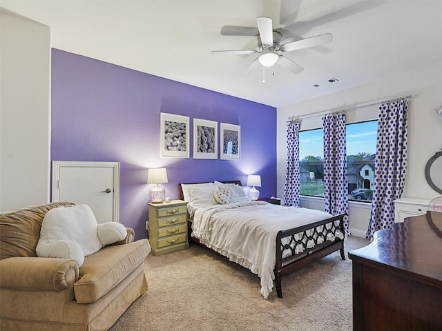 bedroom featuring ceiling fan and light carpet