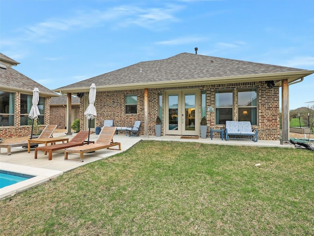 back of house with a yard, a patio area, and french doors