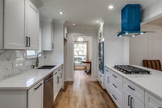 kitchen featuring white cabinetry, sink, stainless steel appliances, island exhaust hood, and plenty of natural light