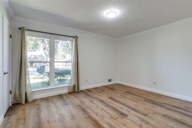 unfurnished room with a textured ceiling, light hardwood / wood-style floors, and crown molding