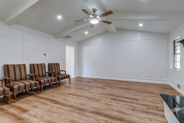 living area with lofted ceiling with beams, ceiling fan, and light wood-type flooring