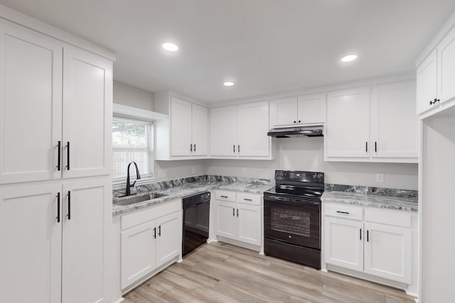 kitchen featuring under cabinet range hood, a sink, light wood-style floors, light stone countertops, and black appliances