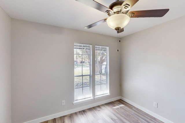 empty room with light wood-type flooring, ceiling fan, and baseboards