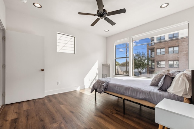 bedroom featuring baseboards, ceiling fan, dark wood-type flooring, and recessed lighting