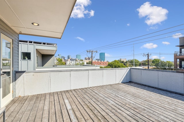 wooden deck with a city view