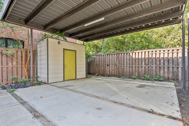 view of patio featuring an outdoor structure and a fenced backyard