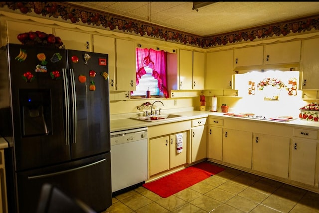 kitchen with light tile patterned floors, white appliances, and sink