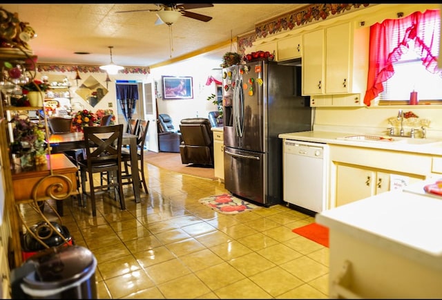 kitchen featuring ceiling fan, sink, stainless steel refrigerator with ice dispenser, white dishwasher, and light tile patterned floors