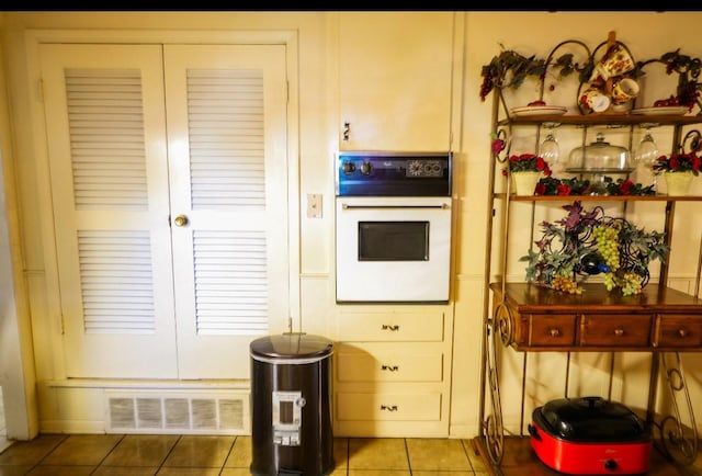 kitchen featuring white oven and light tile patterned floors