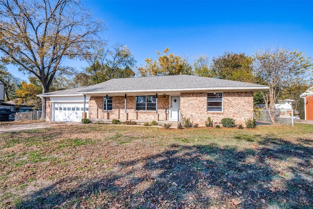 single story home featuring a front lawn and a garage