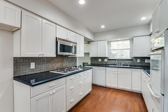 kitchen featuring dark wood-type flooring, white cabinetry, sink, and stainless steel appliances