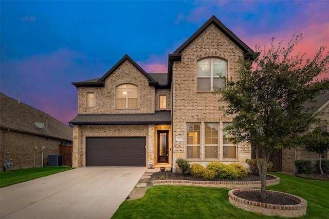 french country style house with a lawn, cooling unit, and a garage